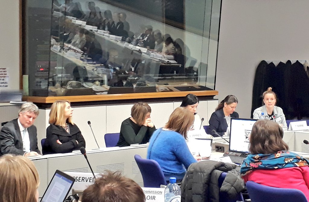 a group of high-level politicians and civil society representatives sitting in a chamber of the European Parliament