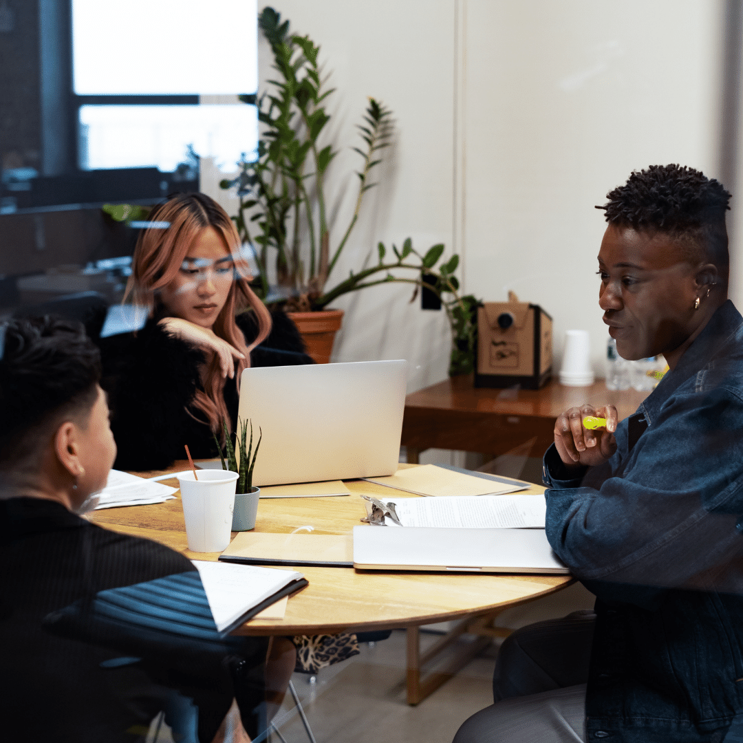 A group of co-workers of varying genders having a meeting