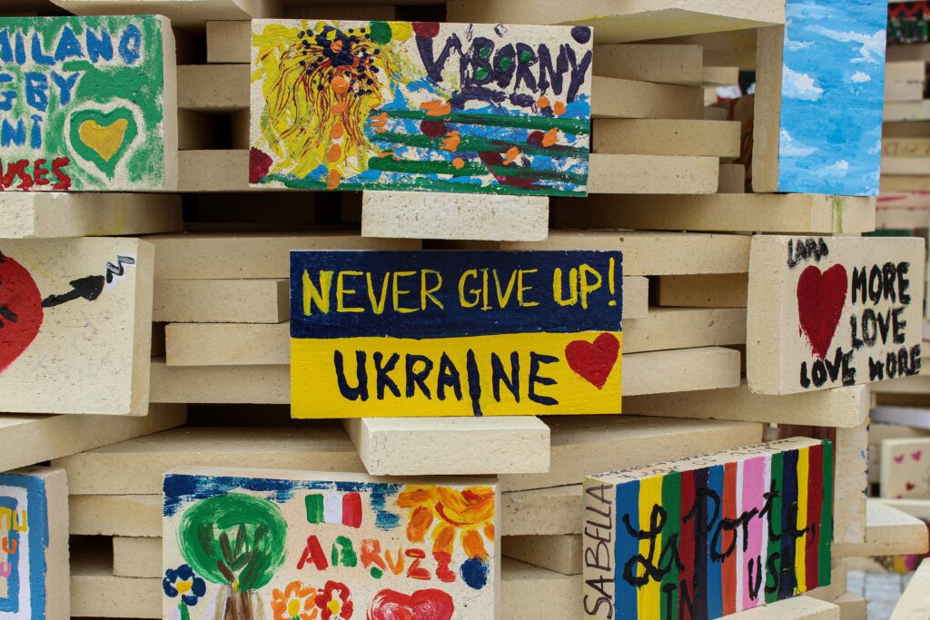 A drawing says "Never Give Up! Ukraine"