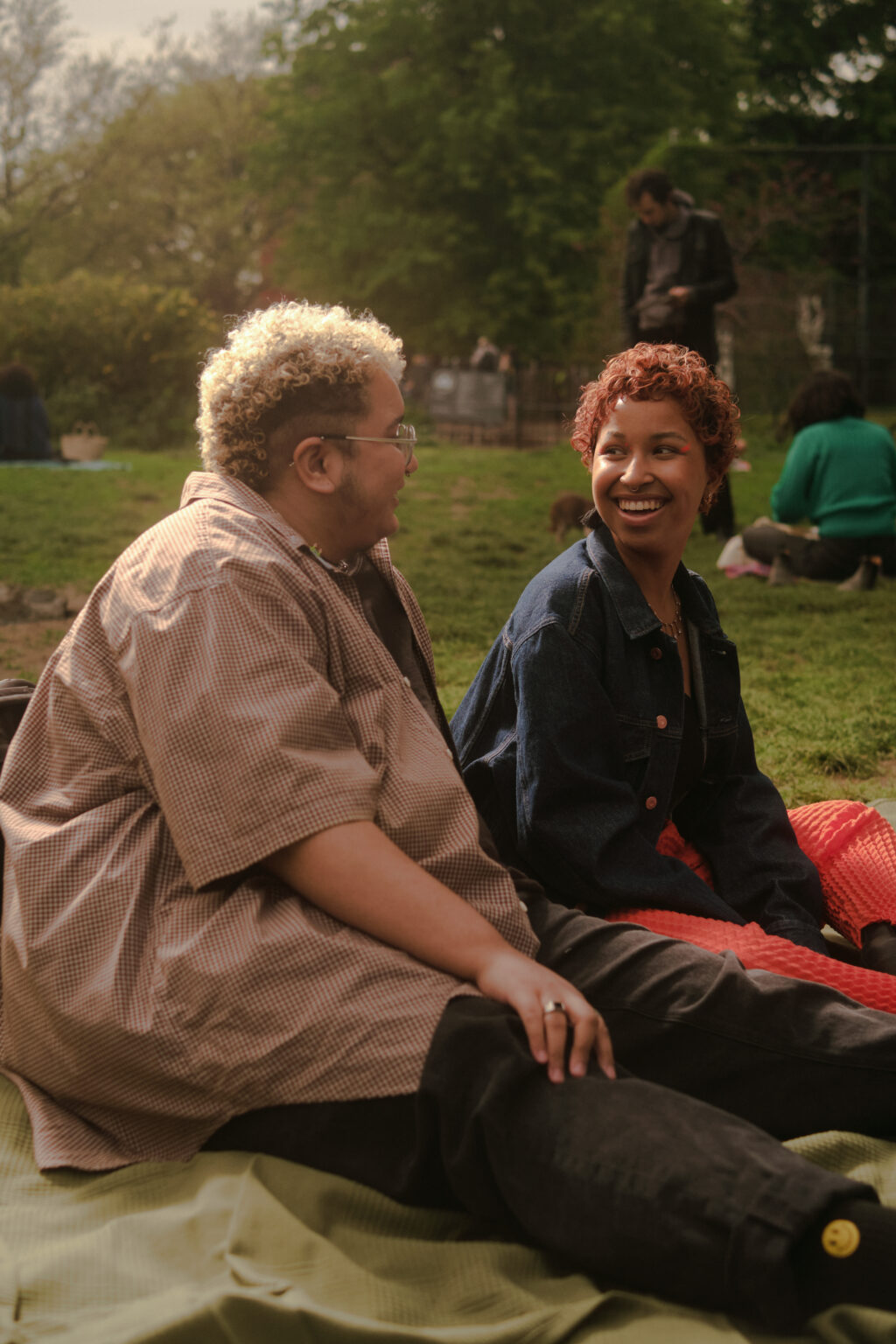 A trans couple sharing a moment in the park